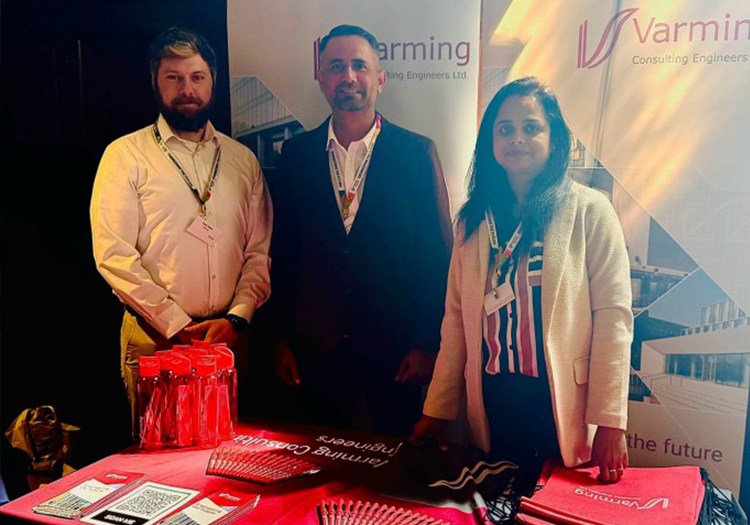 Three Varming Consulting Engineers representatives at company stand during Global Engineers Series 2025 with branded materials on display.