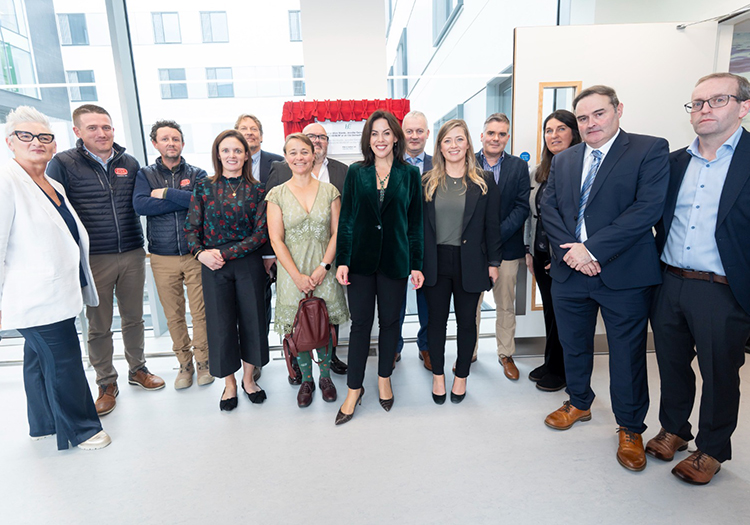Group of project team members at the official opening of the new Acute Inpatient Ward Block at University Hospital Limerick, standing in front of the unveiling plaque inside the hospital.