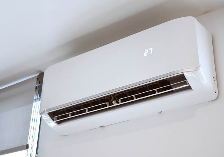 Wall‑mounted VRV air conditioning unit providing energy‑efficient heating and cooling in commercial building interior.